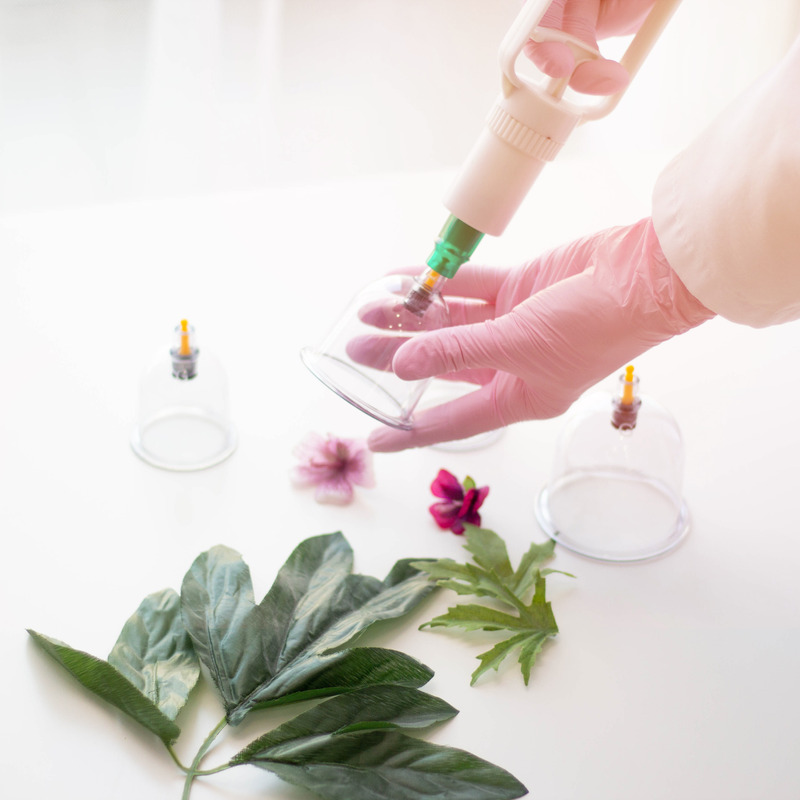lady in gloves holding cups near leaves